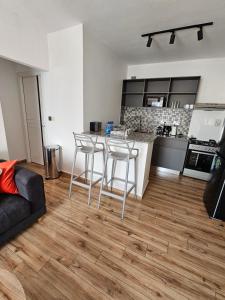 a kitchen with a table and chairs in a living room at orana homes II in Ruiru