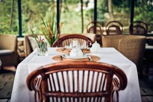 a table in a restaurant with a white table cloth at Quinta Verde Sintra - Casa de Campo in Sintra