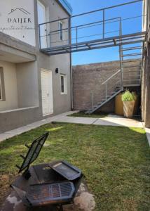 a chair sitting in the yard of a building at Daher Apartment Homes in La Consulta +4 photos