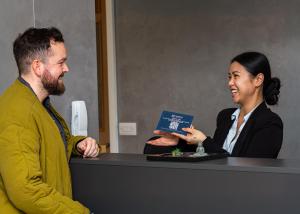 a man and a woman sitting at a desk at HQ Aparthotel Farnborough in Farnborough