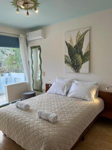 a bedroom with a bed with two towels on it at Villa Garden and Sea Lefkada in Lygia +35 photos