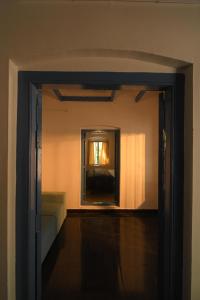an open door to a room with a mirror at Haust in Varkala
