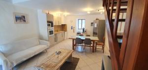 a living room with a couch and a table at Maison typique corse pour 4 personnes in Zonza