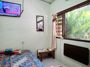 Rúm í herbergi á Ngampilan Backpacker Hostel