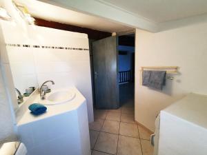 a white bathroom with a sink and a shower at Maison typique corse pour 4 personnes in Zonza