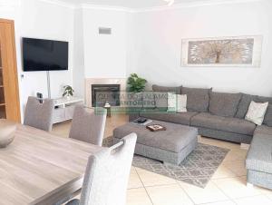 a living room with a couch and a table at Moradia Townhouse S Sebastião F in Guia