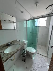 a bathroom with a shower and a toilet and a sink at Domus Hotel Cidade Nobre - Ipatinga in Ipatinga +36 photos