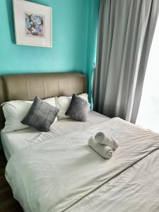 a bed with two towels sitting on top of it at Hotel 57 Subang Jaya in Subang Jaya +5 photos