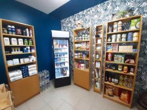 a grocery store aisle with shelves and a refrigerator at ZEcamping 4 étoiles familial avec pataugeoire et jacuzzi in Coulon +70 photos