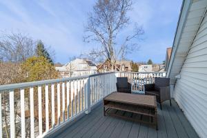 a balcony with a table and chairs on a porch at Roslindale village condos in Boston