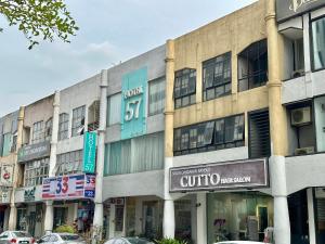 a building with cars parked in front of it at Hotel 57 Subang Jaya in Subang Jaya