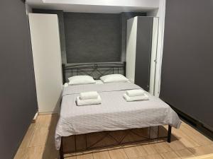 a bedroom with a bed with two towels on it at Kolokotroni Apartment in Piraeus