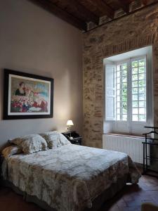 a bedroom with a large bed and a window at Villa Carmen del Rosal in Miraflores de la Sierra +23 photos