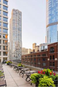 a row of benches in a city with tall buildings at Courtyard by Marriott Chicago Downtown/River North in Chicago