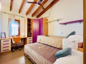 a bedroom with two beds and a desk and a desk at Casa Laura by Sun & Sea Homes in Moraira +20 photos