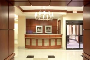 a lobby with a reception desk and a chandelier at Courtyard Boston Copley Square in Boston
