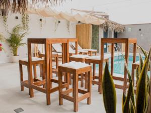 a group of chairs and tables and a pool at Narea San Bartolo in San Bartolo