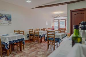 a dining room with tables and chairs at Casa Rural Altzibar-berri in Urnieta