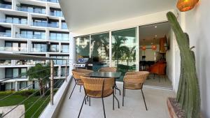 a balcony with a table and chairs and a building at Estudio Marino in Nuevo Vallarta