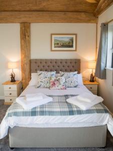 a bedroom with a large bed with two night stands at Braisty woods - Knotty & Nice in Harrogate