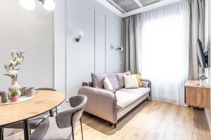 a living room with a couch and a table at SuperApart Mińska Apt 3 - Blisko Stadionu Narodowego in Warsaw
