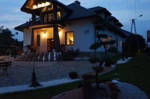 a house with a staircase in front of it at Dworek w Dawnej Szkole in Sieradz