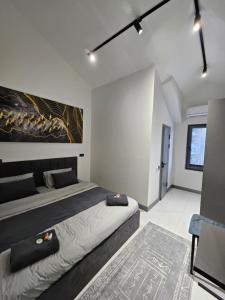 a bedroom with two beds and a painting on the wall at Panorama Lux Guest House in Chimgan +45 photos
