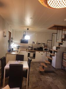a kitchen and dining room with a table and chairs at A cosy little house in Solsidan