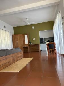 a living room with a couch and a table at Mahogany by Exuberance Stays in Wayanad