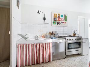 a kitchen with a sink and a stove at 1 2 3 Soleil, Piscine, Lac, 5 chambres, 12 pers in Saint-Pierre