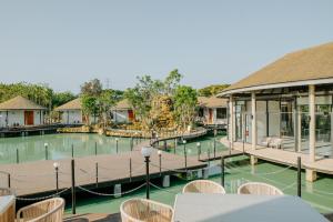 a pool at a resort with tables and chairs at Ellipse Boutique Phayao in Phayao +19 photos