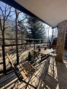 a wooden bench sitting on top of a balcony at Micic Apartment 2 Divcibare in Divčibare