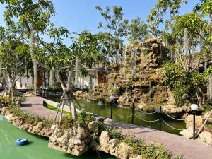 a boat in the water at a resort at Ellipse Boutique Phayao in Phayao
