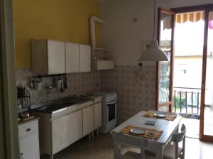 a kitchen with white cabinets and a table in it at Intorno Firenze B&B in San Piero a Sieve