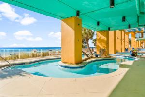 a swimming pool with the ocean in the background at Splash Beach Resort by Panhandle Getaways in Panama City Beach +5 photos