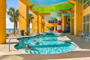 a pool at a resort with people in it at Splash Beach Resort by Panhandle Getaways in Panama City Beach