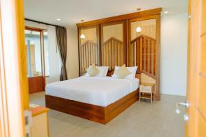 a bedroom with a large bed with white sheets at Ellipse Boutique Phayao in Phayao +36 photos
