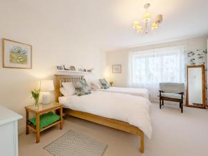 Un dormitorio con una cama grande y una lámpara de araña. en Wealden House - Westhampnett, en Westhampnett