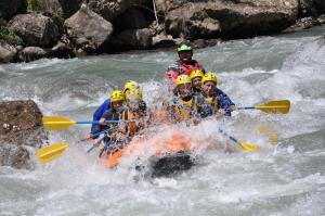 a group of people in a raft in a river at Parcelas Chill-Outdoor in Perarrua