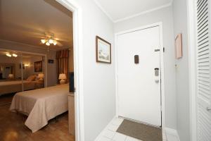 a room with a bed and a door leading to a bedroom at Sandpiper Cove 2043 in Destin +29 photos