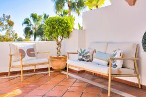 two chairs and a couch on a patio at Luxury Duplex Penthouse Sea Views in Marbella Golden Mile in Marbella
