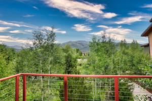 a red railing on a balcony with mountains in the background at Majestic Getaway in Steubenville