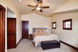 a bedroom with a bed and a ceiling fan at Majestic Getaway in Steubenville