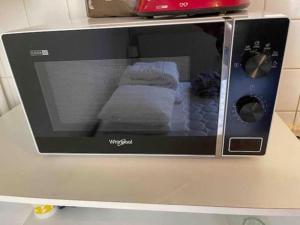 a microwave on a counter with a window on it at Lons City Studio in Lons-le-Saunier