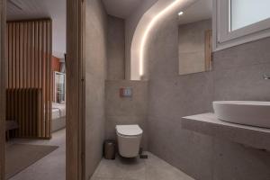 a bathroom with a white toilet and a sink at City Vibe Center Family Flat 3 in Thessaloniki