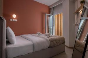 a bedroom with a bed with two stuffed animals on it at City Vibe Center Family Flat 3 in Thessaloniki