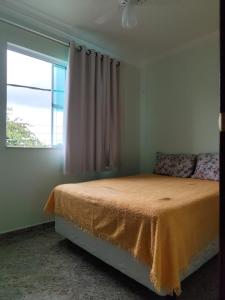 a bedroom with a bed and a window at Apartamento São Pedro da Aldeia frente para lagoa in São Pedro da Aldeia +42 photos