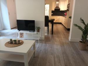 a living room with a tv and a table at cute apartament city center in Gouda