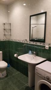 a bathroom with a sink and a toilet and a mirror at Apartment and Private Office in Yerevan