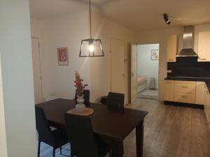 a dining room and living room with a table and chairs at cute apartament city center in Gouda +6 photos